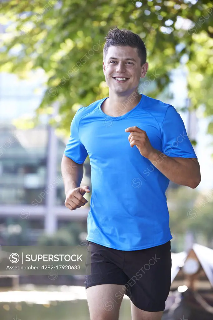 Young Man Running In Urban Setting