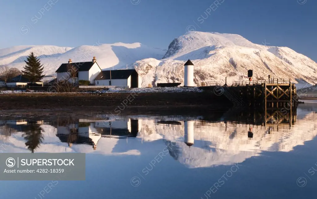 Scotland, Highland, Loch Eil. Corpach Lighthouse on Loch Eil with Ben Nevis and Fort William in the background.