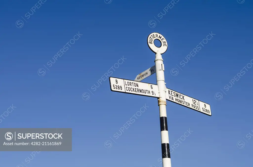 Road sign at Buttermere giving directions to Lorton, Cockermouth and Keswick.