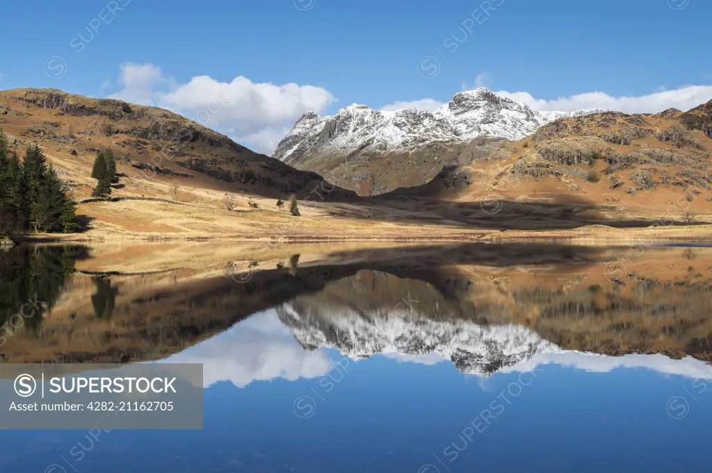 Blea Tarn and snow covered Langdale Pikes.