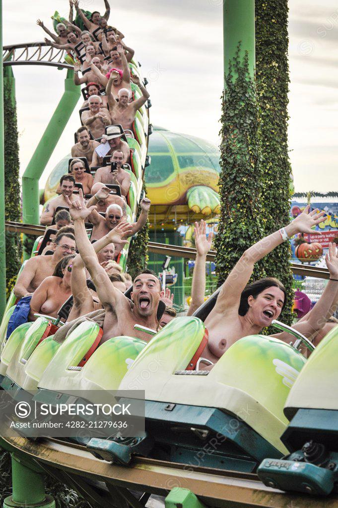 Naked thrill seekers ride the Green Scream roller coaster on a