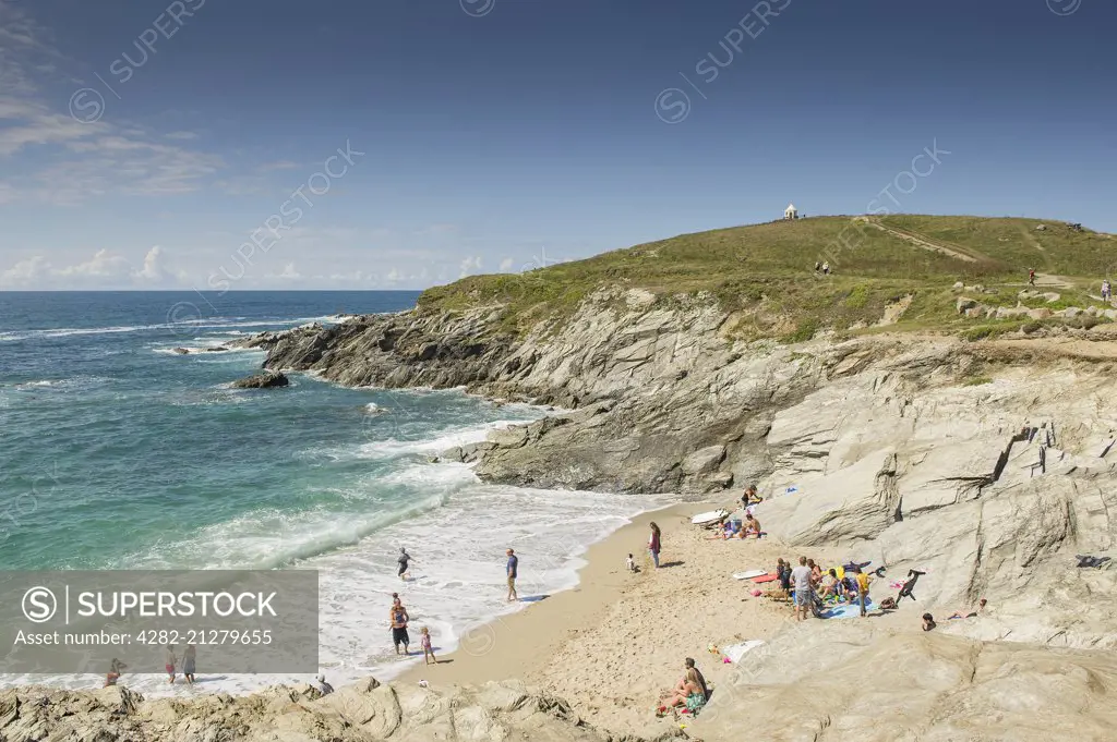 Holidaymakers enjoy the summer weather on a beach on The Headland in Newquay in Cornwall.