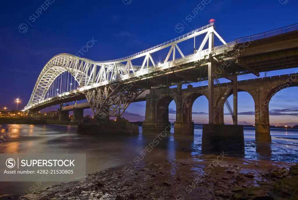 The Runcorn and Widnes transporter bridge over the River Mersey at night.