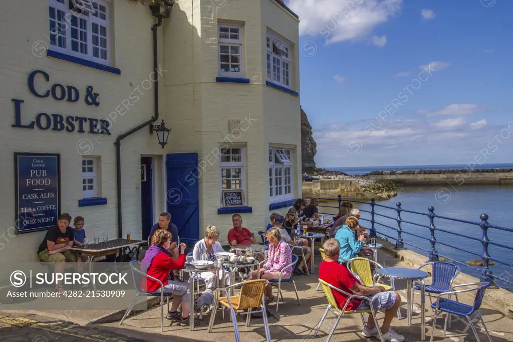 Enjoying a summer day outside a seaside pub.