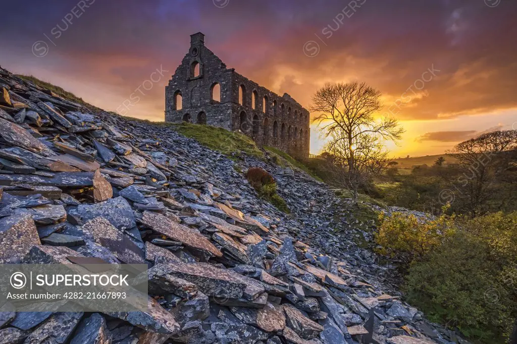 Ynys y Pandy disused slate mill and spoil heaps at sunset in Cwmystradllyn.