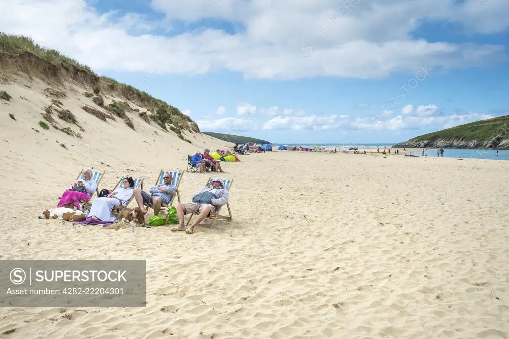 Holidaymakers on Crantock Beach in Newquay in Cornwall.