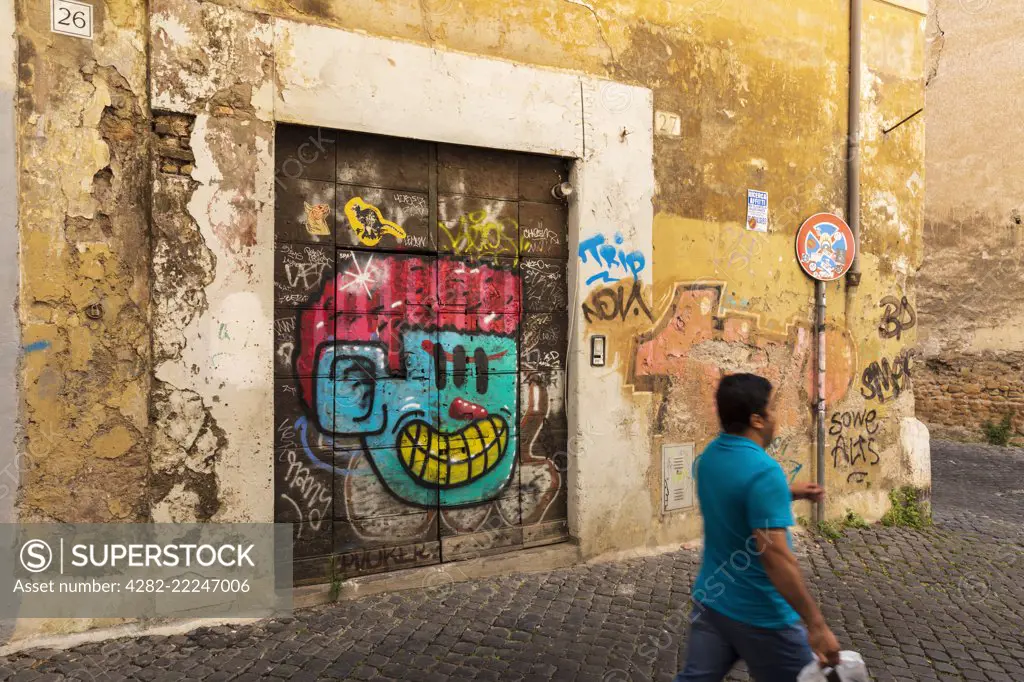 Colourful street art adorns the backstreet walls of Trastevere.