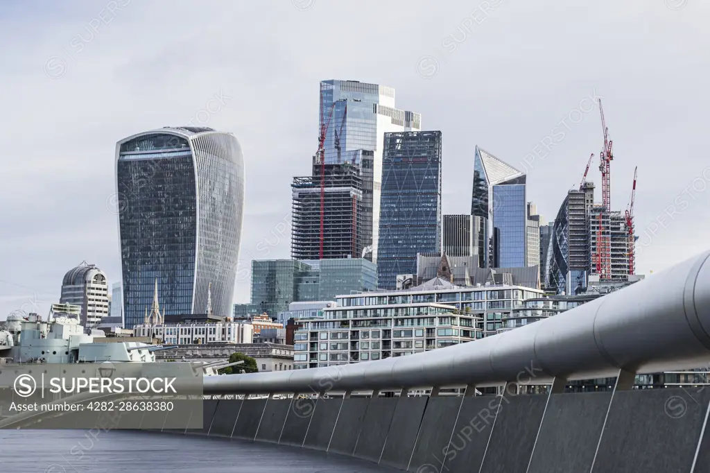 The Square Mile of London's financial district pictured over a curve around The Scoop on the London waterfront.