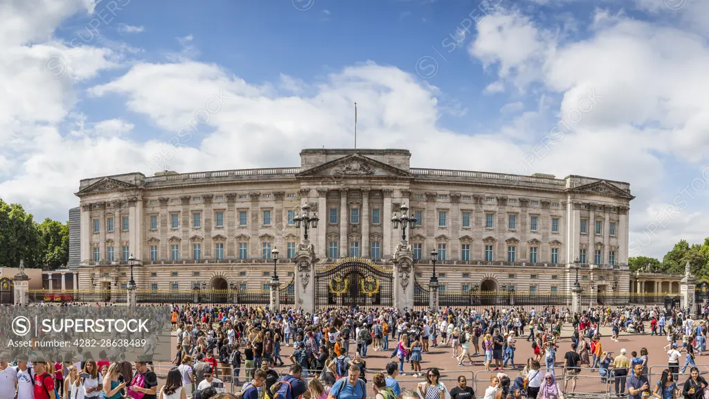 Tourists outside Buckingham Palace in London after gathering to watch the Changing of the Guard ceremony.