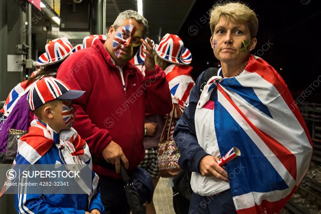 England, London, Stratford. A group of British fans return home after a day at a sporting event.