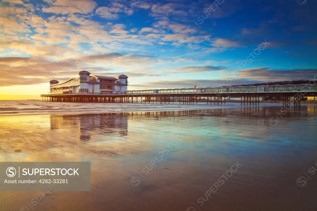 England, Somerset, Weston Super Mare. Golden evening light falls on the Grand Pier at Weston Super Mare.