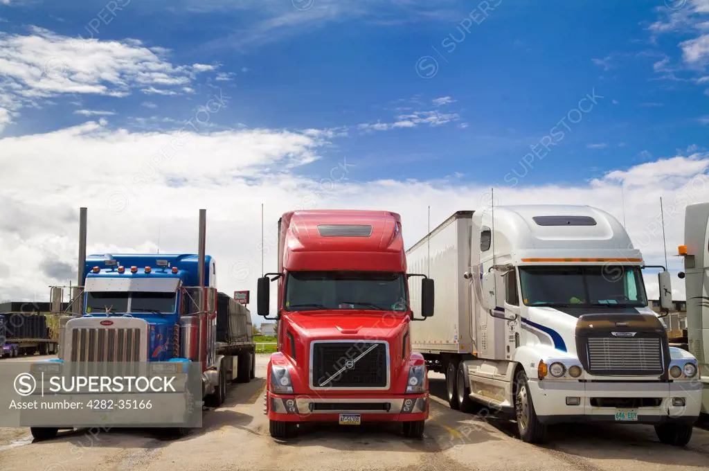 USA, South Dakota, Sheridan. Three big rigs parked at gas station in Sheridan in South Dakota.