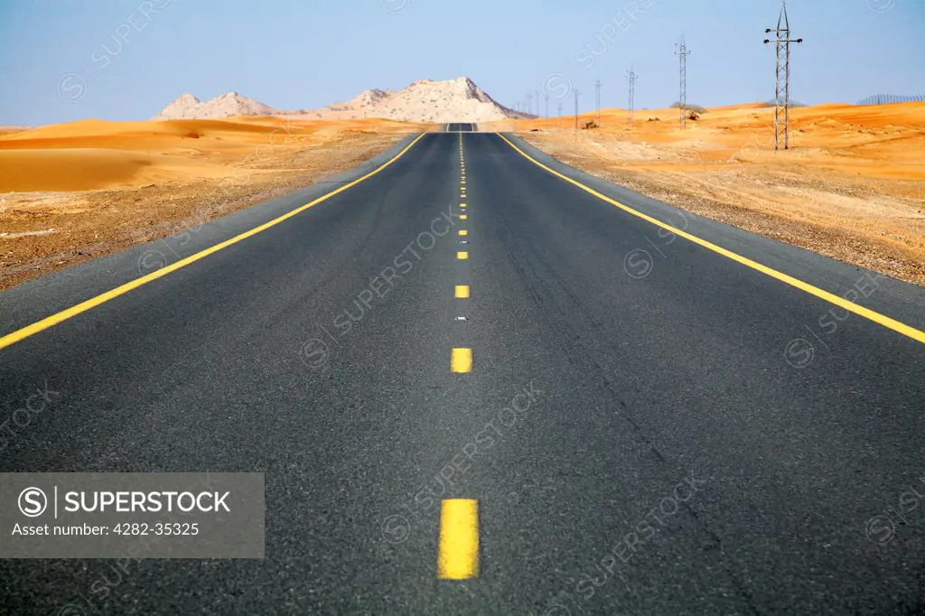 United Arab Emirates, Dubai, Dubai Desert. A seemingly endless road in the Dubai desert.