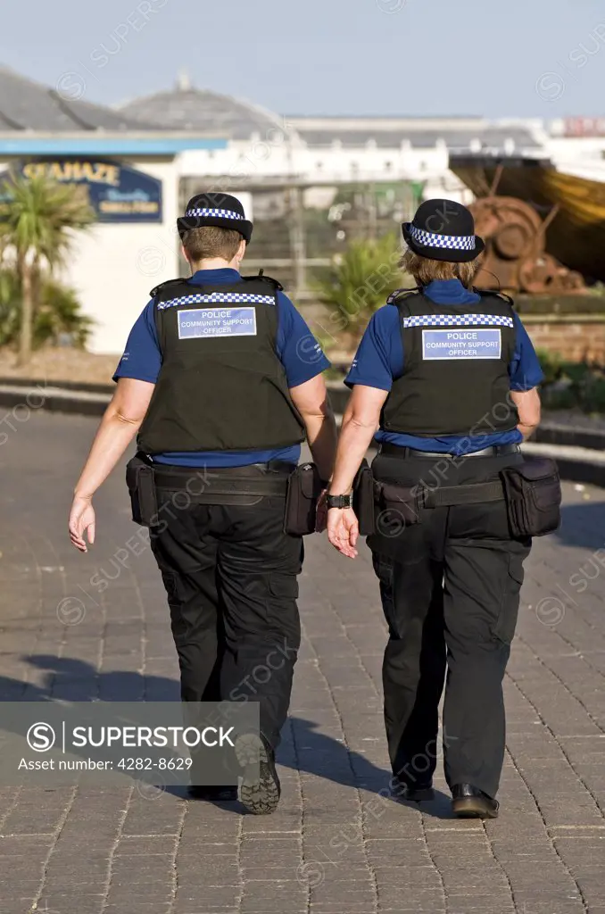 England, City of Brighton and Hove, Brighton. Two female Police Community Support Officers patrolling Brighton seafront.