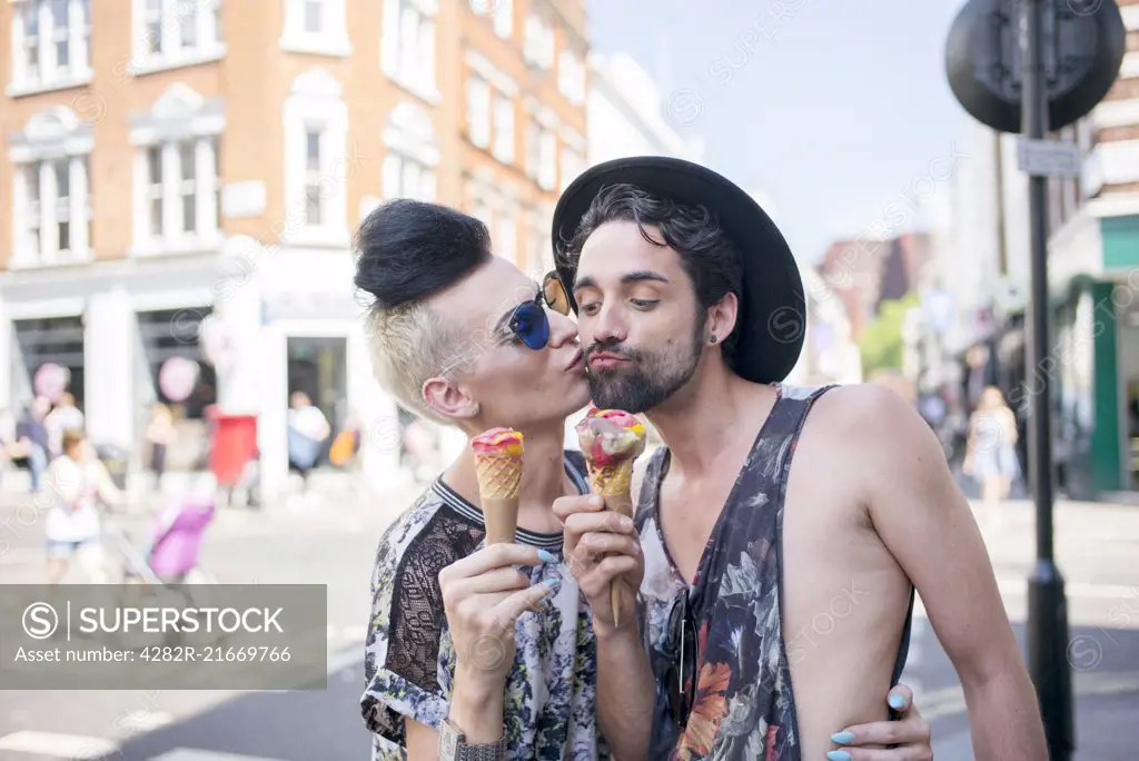 A gay couple enjoy an ice cream on a day out in London.