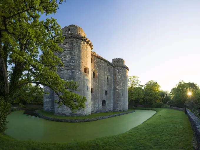 Nunney Castle and moat at sunrise.