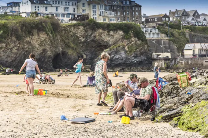 Holidaymakers enjoying themselves relaxing on Towan Beach in Newquay in Cornwall.