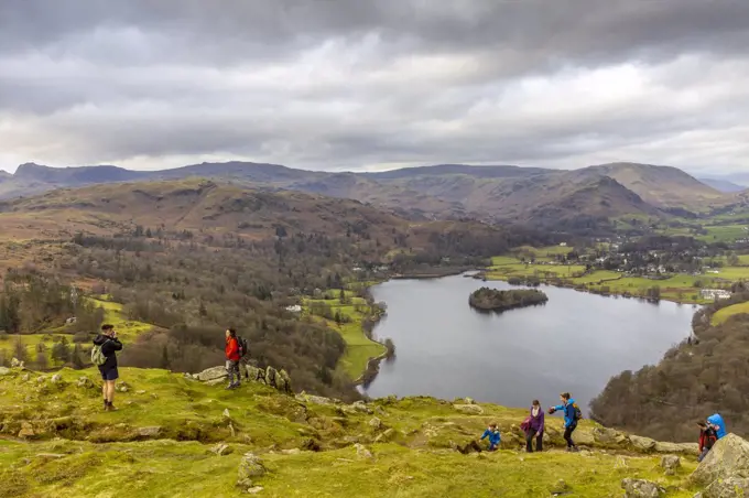 Hikers on Loughrigg Fell with Lake Grasmere in the background.