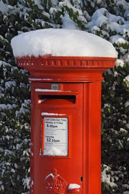 England, North Yorkshire, York. Traditional red post box in winter.