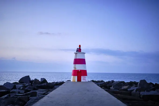 A lighthouse off the coast of Portugal on an early January morning.