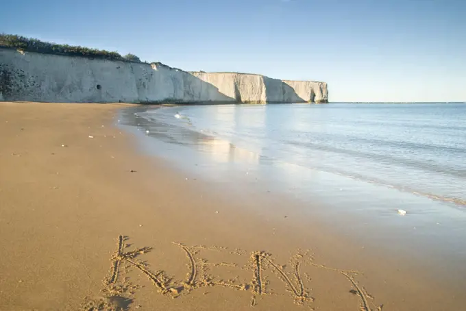 England, Kent, Botany Bay. A view along the beach towards a natural hole in the chalk cliff at Botany Bay on the east coast of Kent.