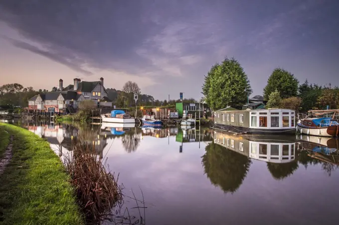 Houseboat on the river Soar with cruisers near The Otter pub and restaurant.