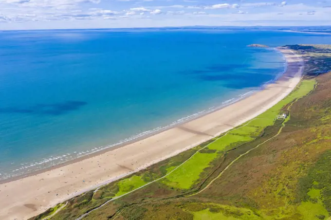 Aerial view of the longest beach in Rhossili Bay in Gower in Wales.