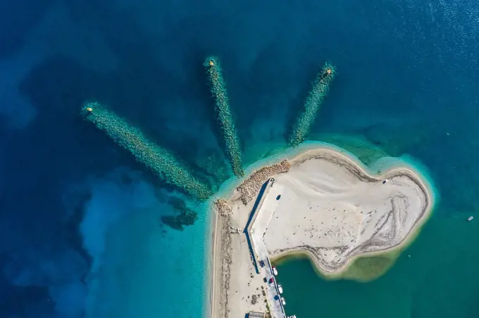 A dinosaur shape beach captured from above in Lefkada in Greece.