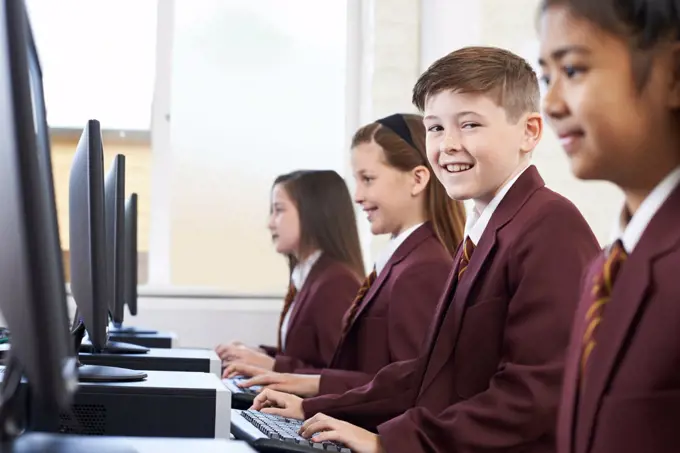 Pupils Wearing School Uniform In Computer Class 