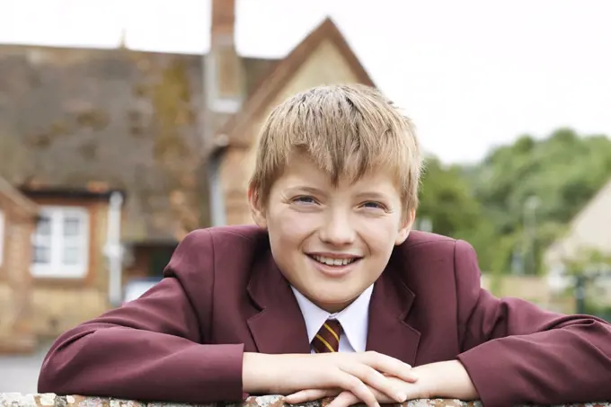 Portrait Of Boy In Uniform Outside School Building