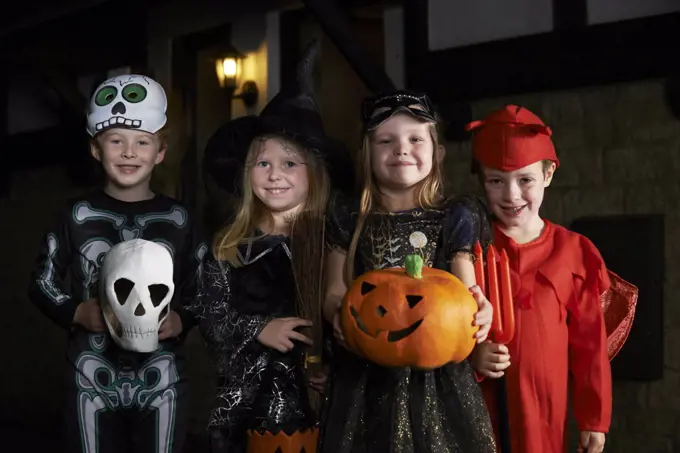 Halloween Party With Children Trick Or Treating In Costume