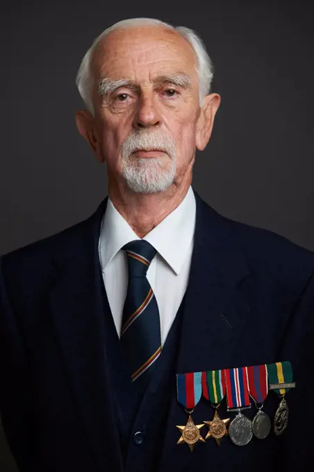 Studio Portrait Of Senior Man Wearing Medals