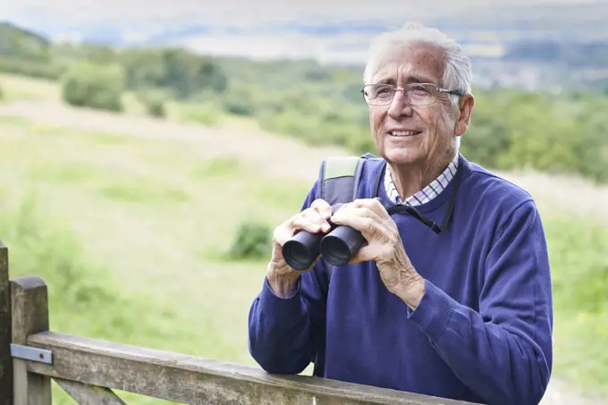 Senior Man On Walk With Binoculars