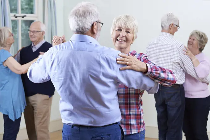 Group Of Seniors Enjoying Dancing Club Together