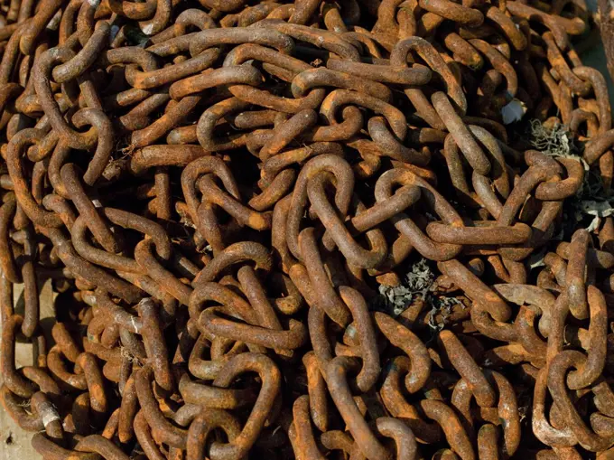 England, North Yorkshire, Whitby. Close up of rusty anchor chains on the quayside.