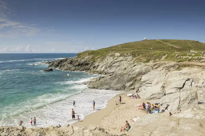 Holidaymakers enjoy the summer weather on a beach on The Headland in Newquay in Cornwall.