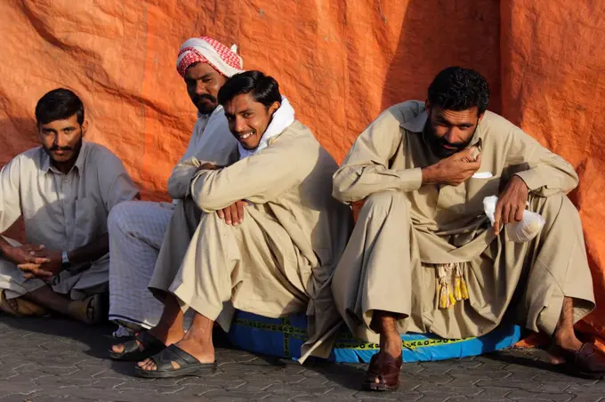 United Arab Emirates, Dubai, Dubai Creek. Dock workers taking a break on Dubai Creek.