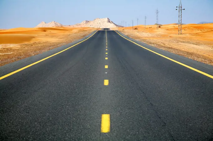 United Arab Emirates, Dubai, Dubai Desert. A seemingly endless road in the Dubai desert.