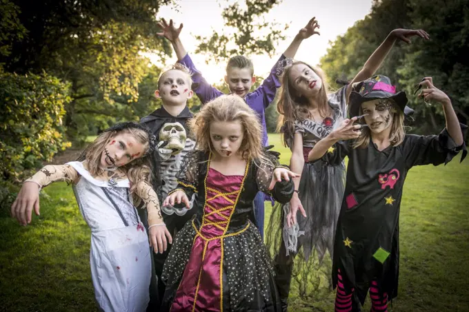 Children pose in zombie costumes for Halloween Night.