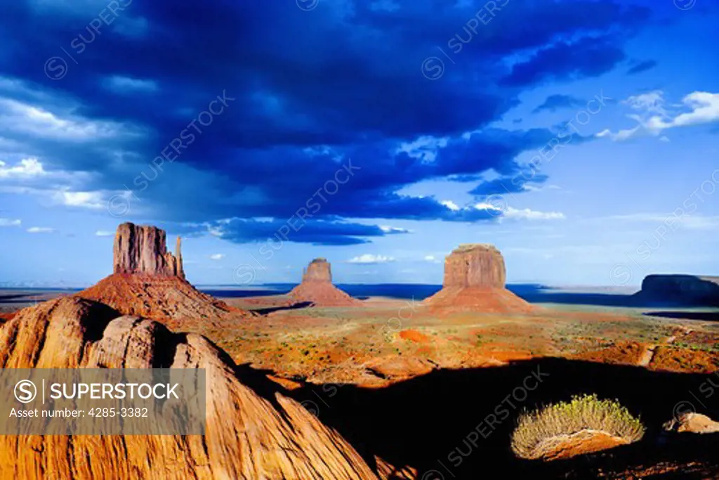 Monument Valley (Arizona / Utah) rock formations, valley and big blue sky with large clouds. (2)