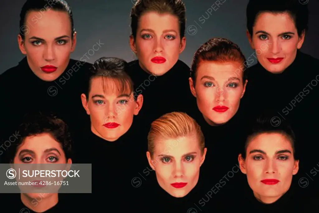 Portrait of eight women draped in black wearing red lipstick with a gray background.