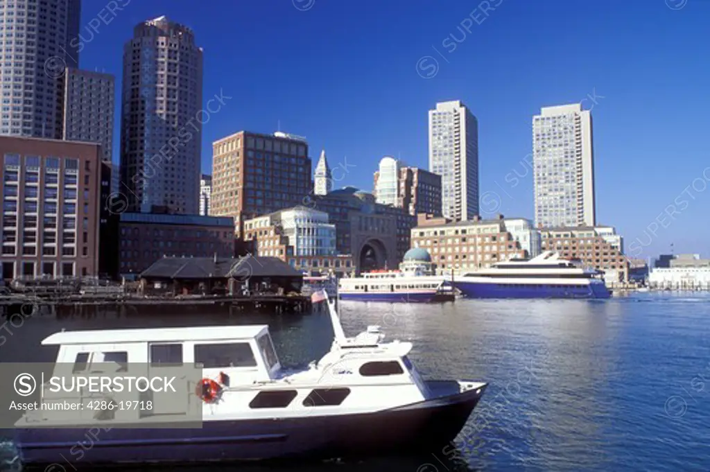 Boston, MA, Massachusetts, Boat touring Boston Inner Harbor with a view of the skyline of downtown Boston.