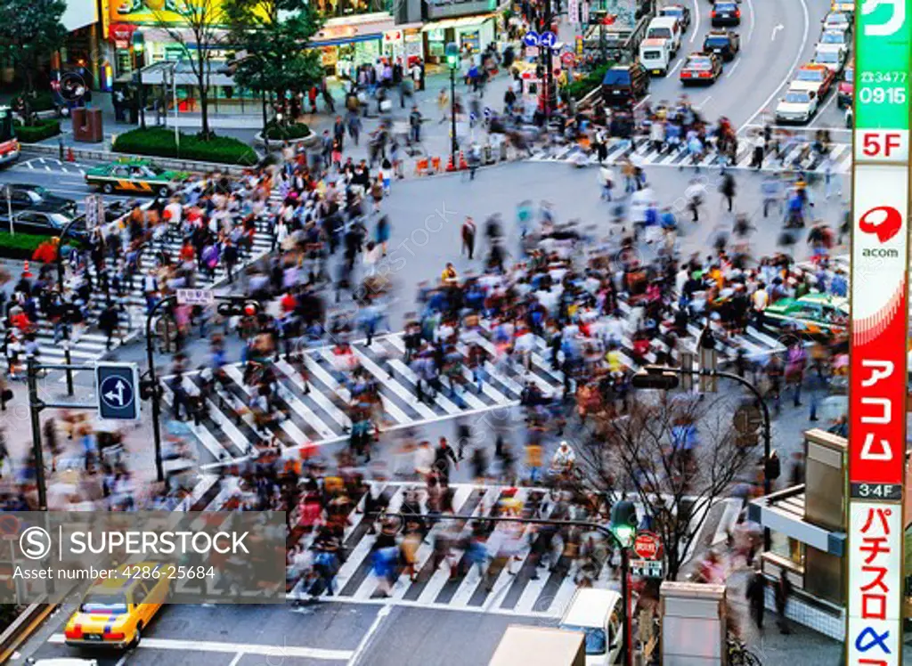 Pedistrians filling crosswalks in Shibuya district of Tokyo