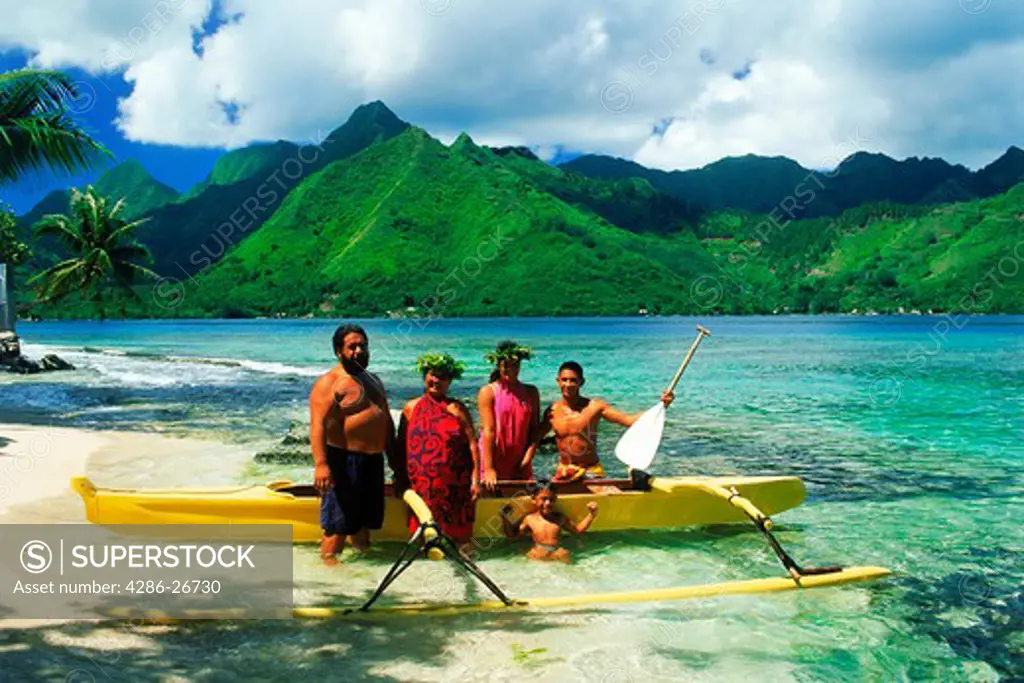 Tahitian family with their outrigger canoe at Opunohu in Moorea 