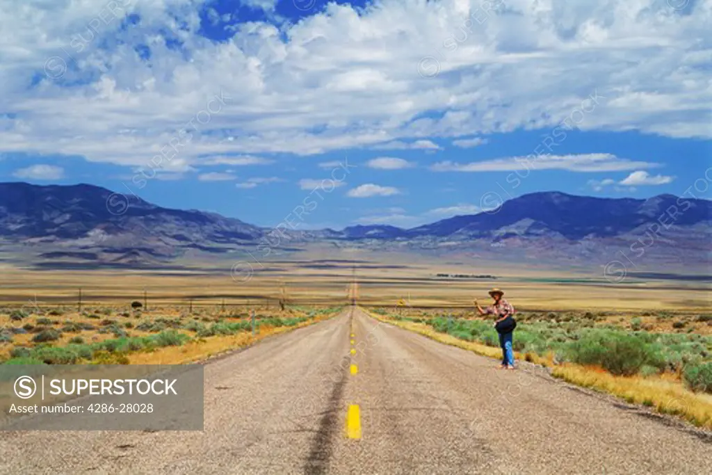 Hitch hiker on Highway 93 crossing the endless Nevada desert