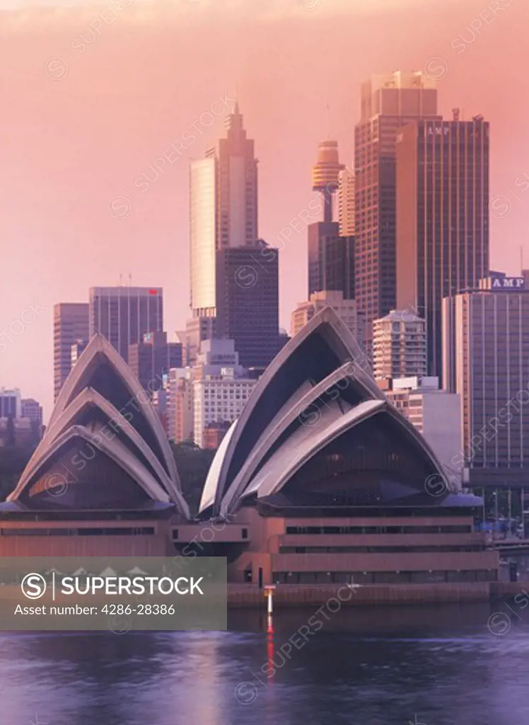 Sky Tower and skyline above Sydney Opera House at dawn