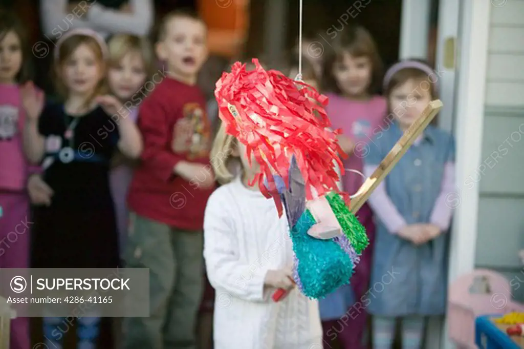 Children Trying to Break Open a Pinata at a Birthday Party