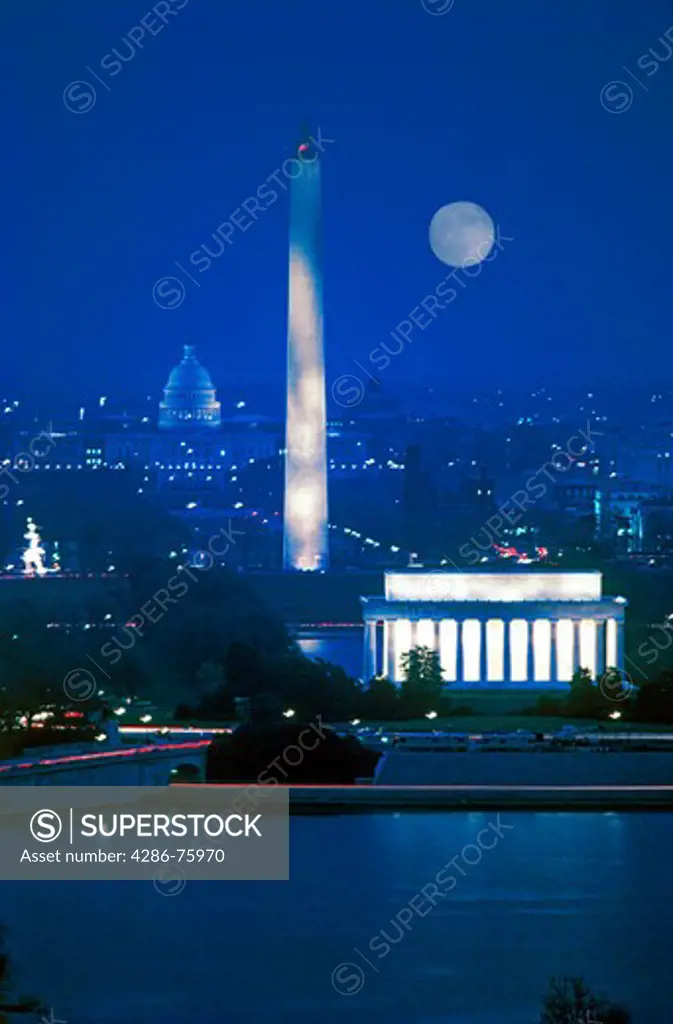 Lincoln Memorial, Washington Monument and Capitol Building illuminated at night with full moon in Washington DC