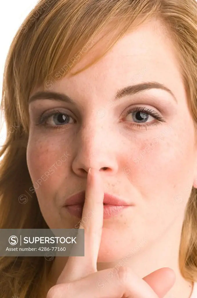 Studio shot of woman making shushing sign