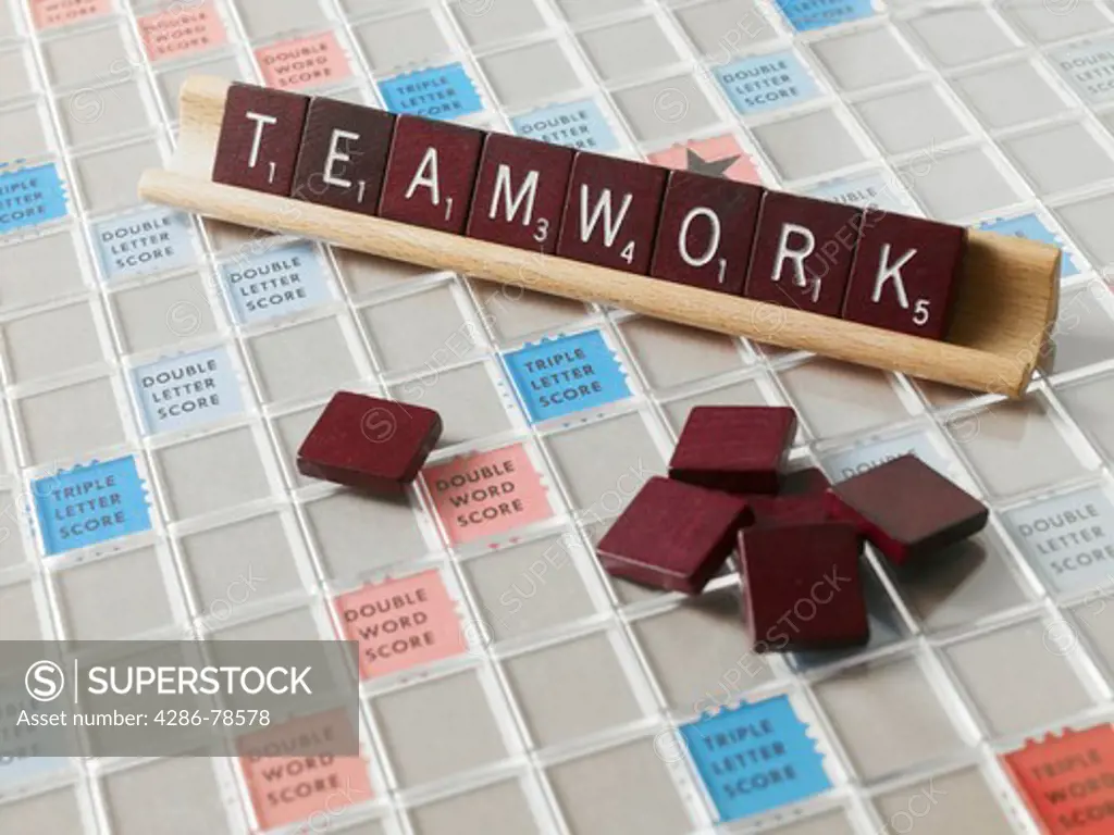 Individual tiles with letters spelling out the word teamwork.